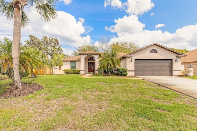 view of front of property featuring a garage, driveway, a front lawn, and stucco siding