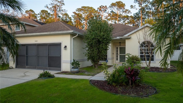 single story home featuring roof with shingles, an attached garage, a front yard, and stucco siding