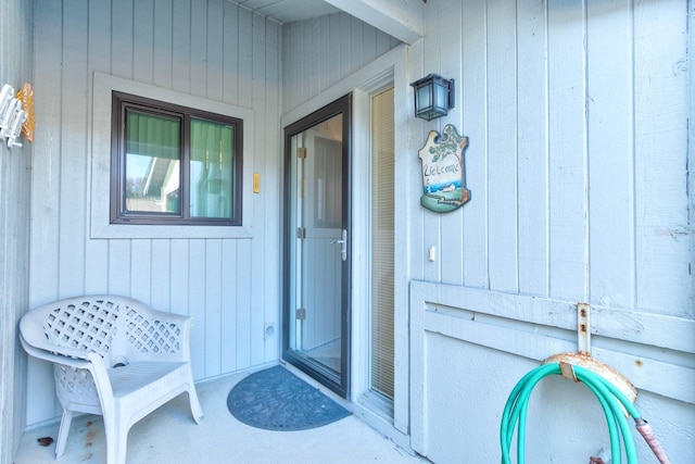 property entrance featuring board and batten siding