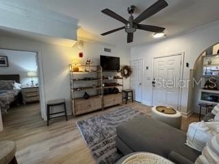 living room featuring ceiling fan and wood finished floors