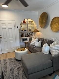 living room featuring ornamental molding and wood finished floors