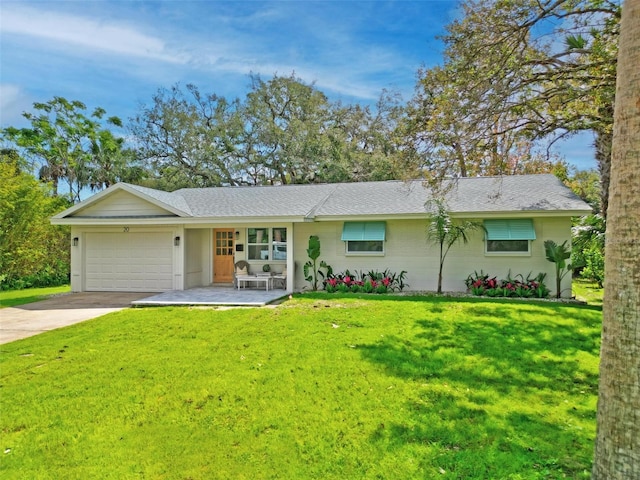 ranch-style house featuring a garage, concrete driveway, and a front yard