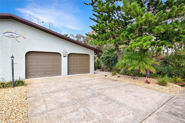 garage with concrete driveway