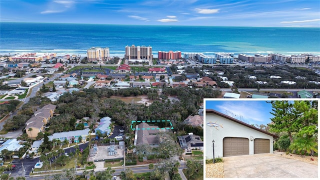 drone / aerial view featuring a water view and a view of city