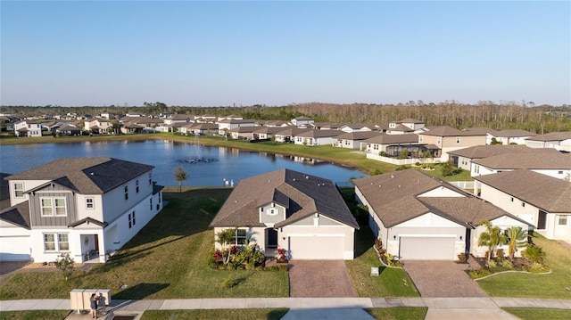 drone / aerial view with a water view and a residential view