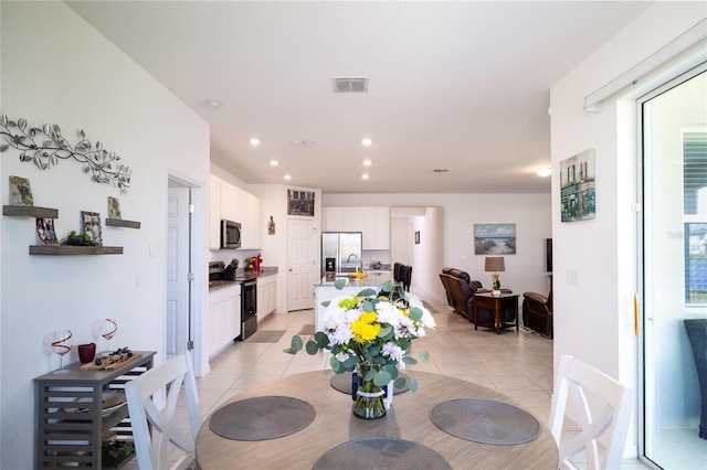 dining room featuring light tile patterned floors, visible vents, and recessed lighting