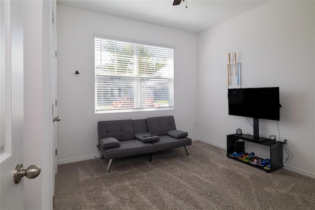 sitting room with carpet floors, ceiling fan, and baseboards