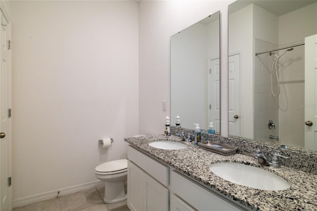 bathroom with walk in shower, a sink, toilet, and tile patterned floors