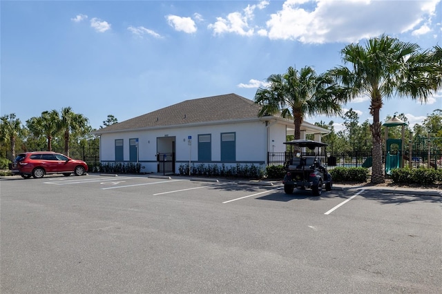 view of property featuring uncovered parking and fence