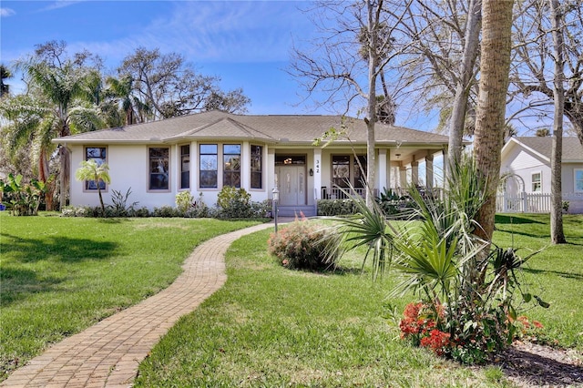 view of front of home featuring a porch, a front lawn, and stucco siding