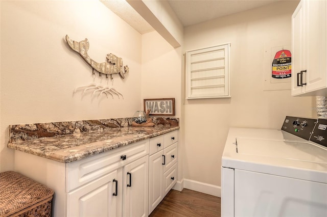 laundry area with cabinet space, baseboards, dark wood-style floors, and washer and clothes dryer