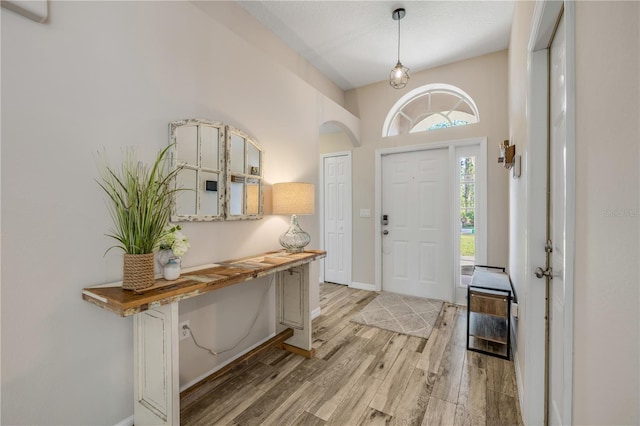 entrance foyer featuring light wood-style floors and baseboards