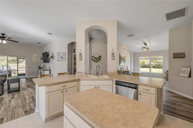 kitchen with open floor plan, visible vents, a sink, and stainless steel dishwasher