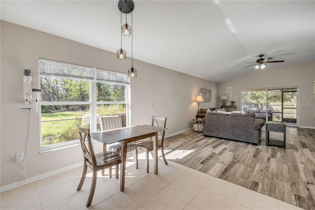 dining room with vaulted ceiling, ceiling fan, wood finished floors, and baseboards