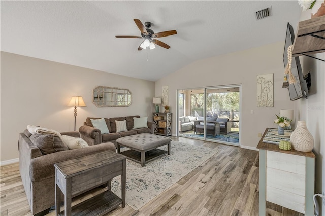 living room with baseboards, visible vents, a ceiling fan, wood finished floors, and vaulted ceiling