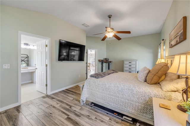 bedroom featuring baseboards, visible vents, ceiling fan, and wood finished floors