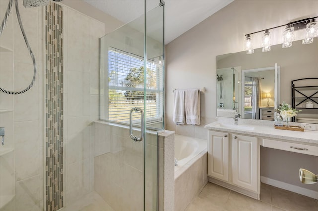 bathroom featuring a stall shower, lofted ceiling, a garden tub, tile patterned flooring, and vanity