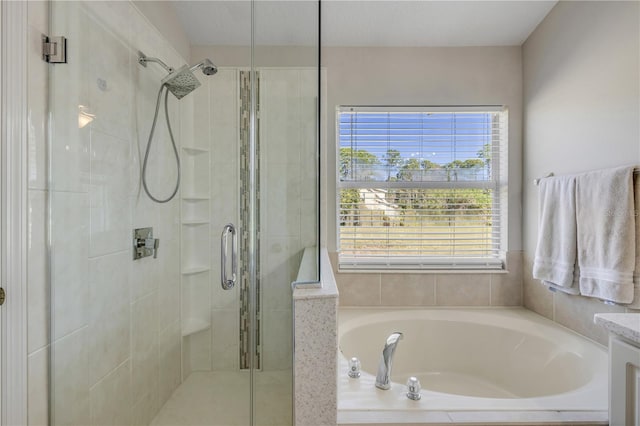 bathroom featuring a garden tub and a shower stall