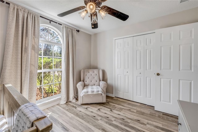 unfurnished room with a textured ceiling, light wood-type flooring, and baseboards