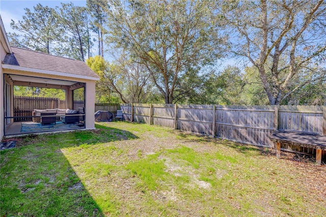 view of yard featuring a fenced backyard, a patio, and an outdoor hangout area