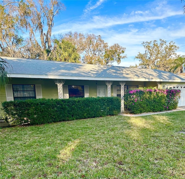 single story home with a garage and a front yard