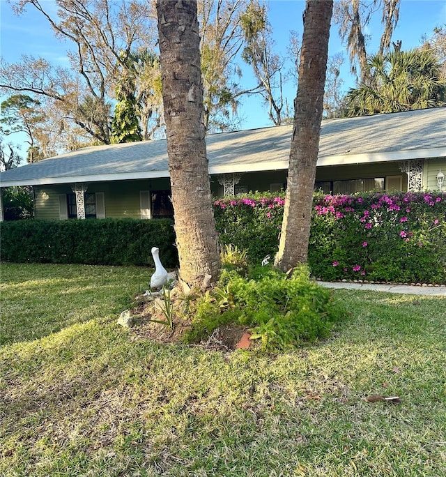 view of side of home with a lawn