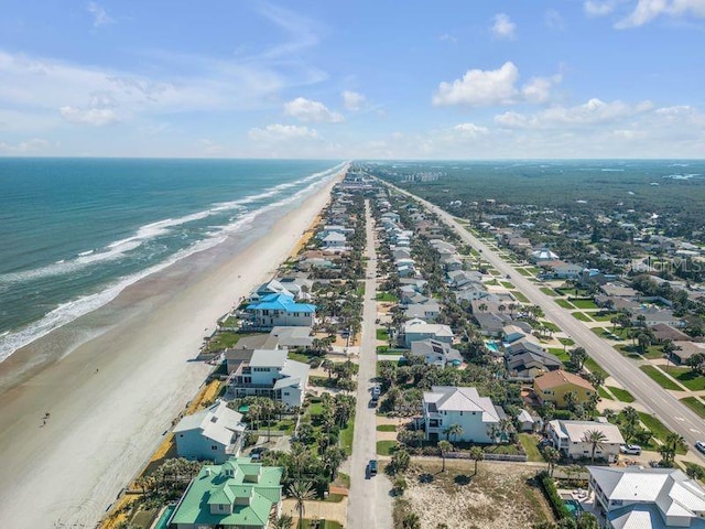 aerial view with a water view and a beach view