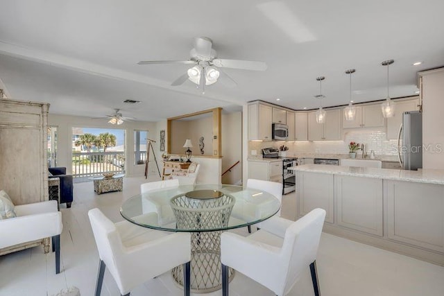 dining space with a ceiling fan and recessed lighting