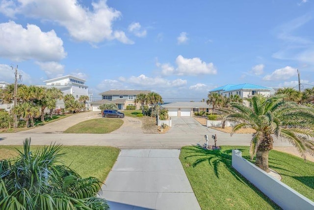 view of property's community featuring a garage, concrete driveway, and a yard