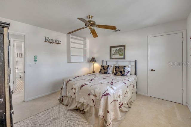 carpeted bedroom with a ceiling fan, visible vents, and baseboards