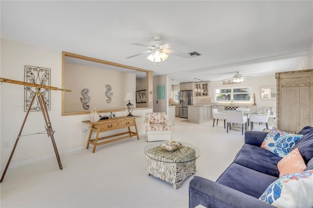 living area with visible vents and a ceiling fan