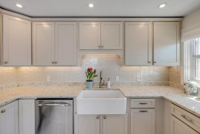 kitchen featuring a sink, decorative backsplash, dishwasher, and recessed lighting