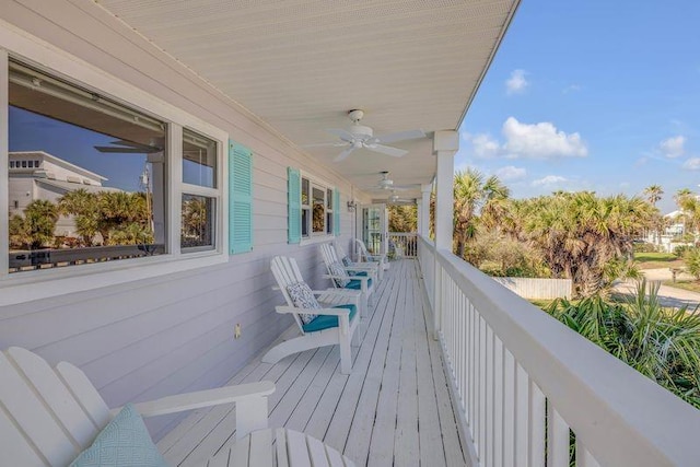 wooden terrace featuring a ceiling fan