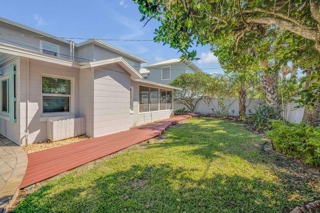 view of yard with a fenced backyard and a wooden deck