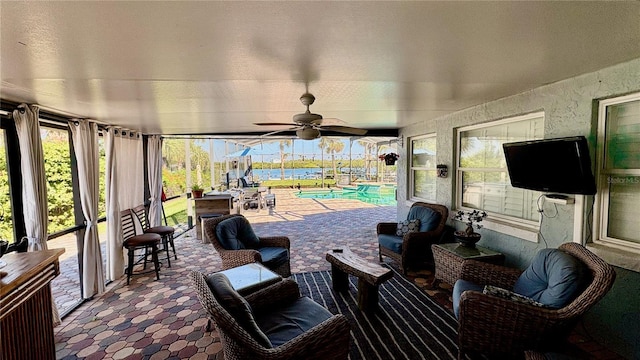 view of patio / terrace featuring an outdoor hangout area, a ceiling fan, and an outdoor pool