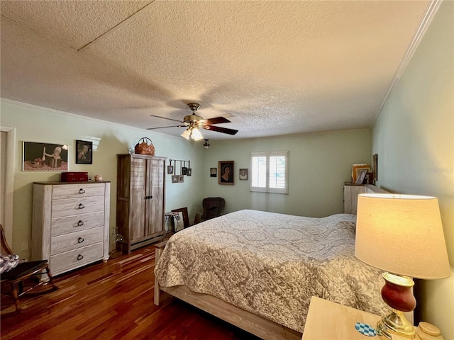 bedroom with dark wood-style floors, a baseboard radiator, ceiling fan, a textured ceiling, and crown molding