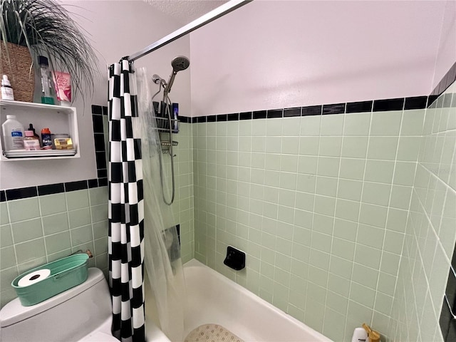 bathroom with shower / bath combo, tile walls, and toilet