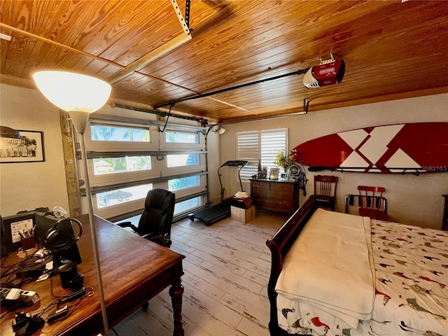 bedroom with a garage, wooden ceiling, and wood-type flooring