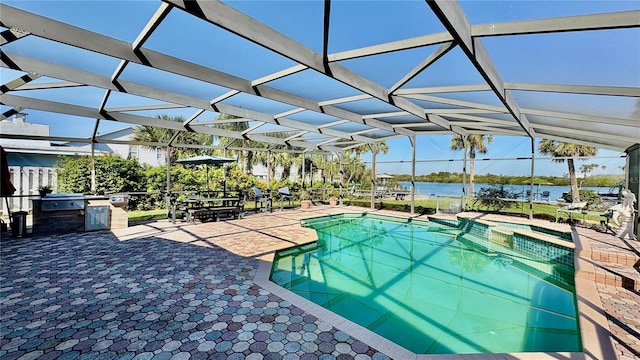 view of pool with a patio area, a water view, a lanai, and a pool with connected hot tub