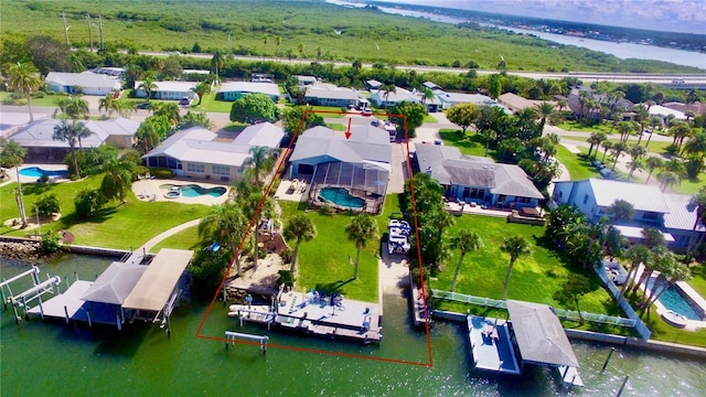 drone / aerial view featuring a water view and a residential view