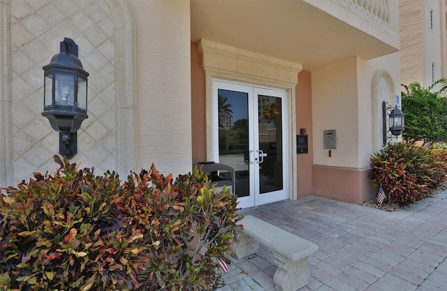 entrance to property with french doors and stucco siding