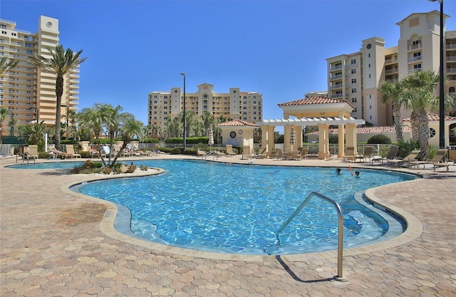 pool with a pergola and a patio