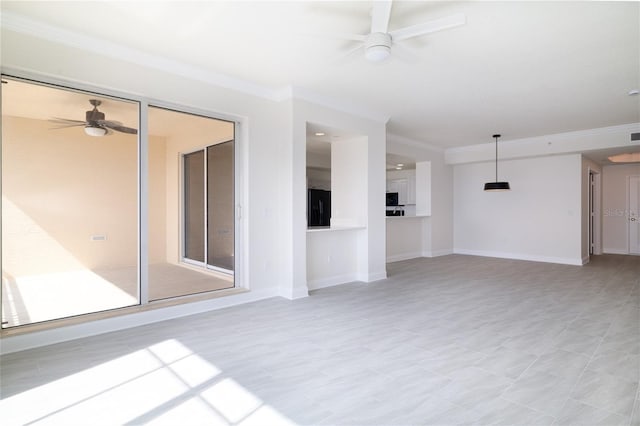 empty room featuring crown molding, baseboards, and a ceiling fan