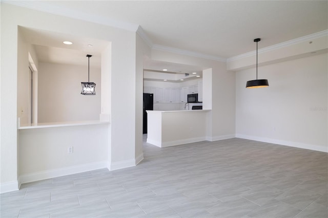 unfurnished living room featuring ornamental molding and baseboards