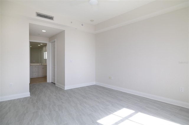 unfurnished room featuring visible vents and baseboards