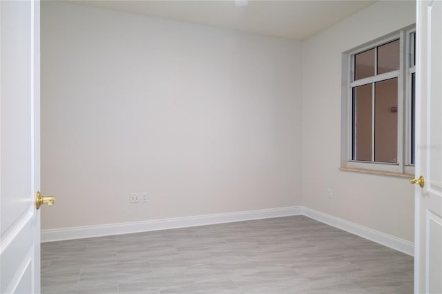 spare room with baseboards