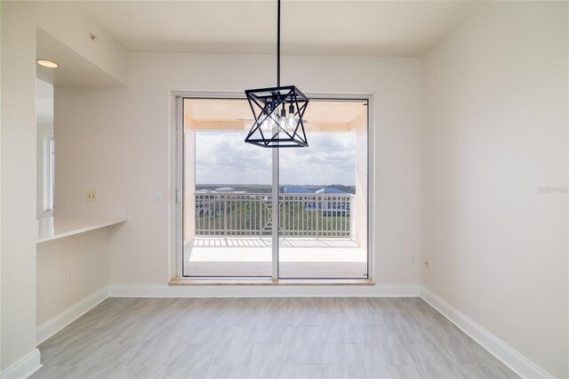 265 Minorca Beach Way Unit 505, New Smyrna Beach, FL 32169 - unfurnished dining area with baseboards