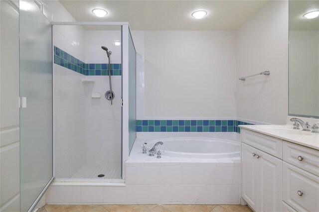 265 Minorca Beach Way Unit 505, New Smyrna Beach, FL 32169 - bathroom with a stall shower, a bath, vanity, recessed lighting, and tile patterned floors