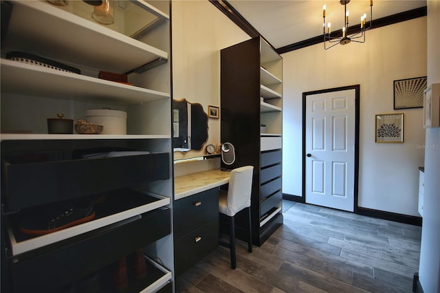 office with dark wood-style floors, a notable chandelier, crown molding, and baseboards