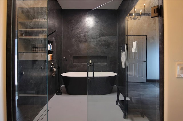 full bathroom featuring a freestanding tub and tile walls